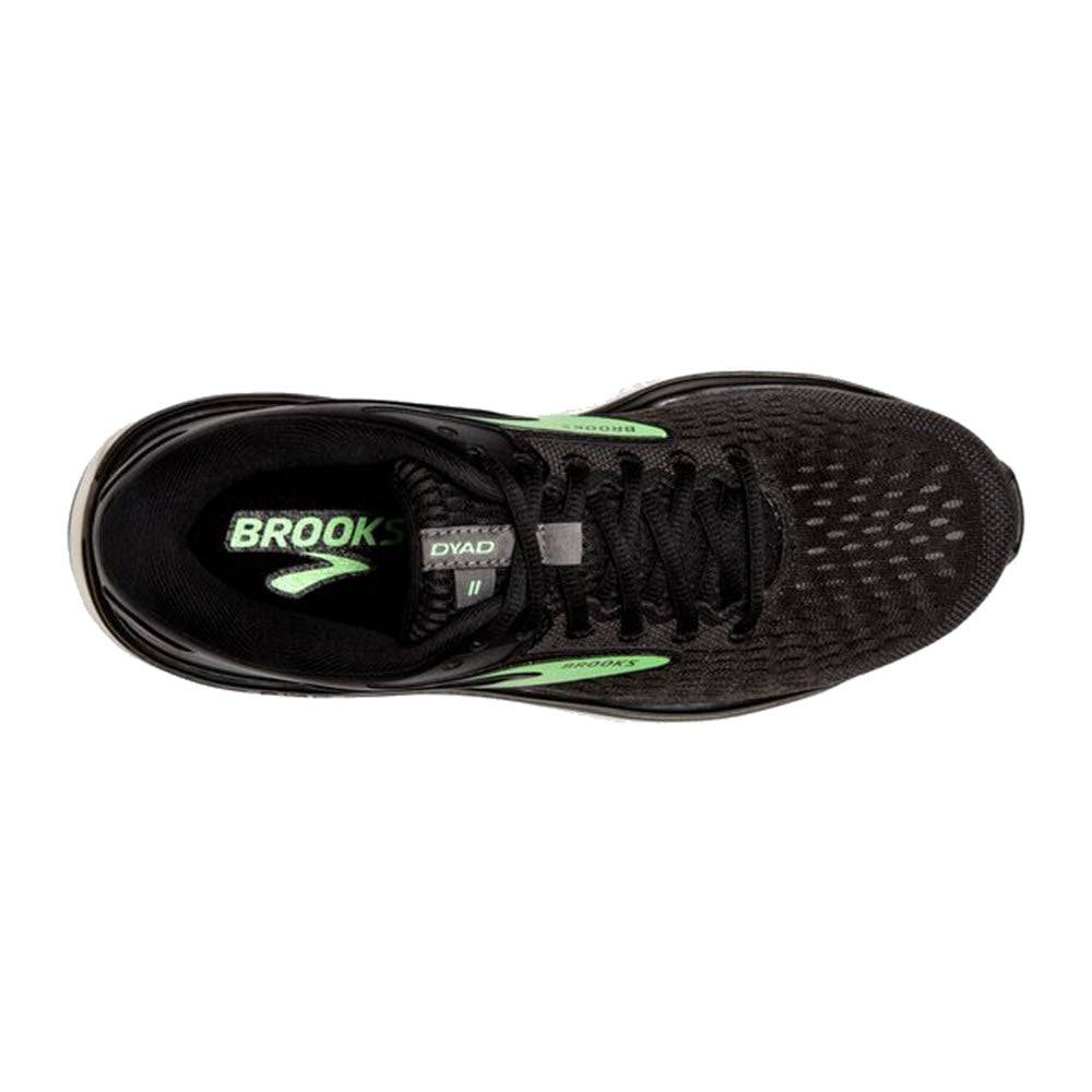 Top view of a single black and gray Brooks Dyad 11 running shoe with green accents, displaying its laces and inner label.