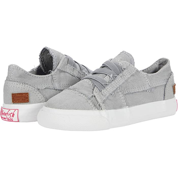 A pair of Blowfish Marley Canvas Sweet Gray Kids slip-on sneakers with white vulcanized synthetic rubber soles and a velcro strap closure.