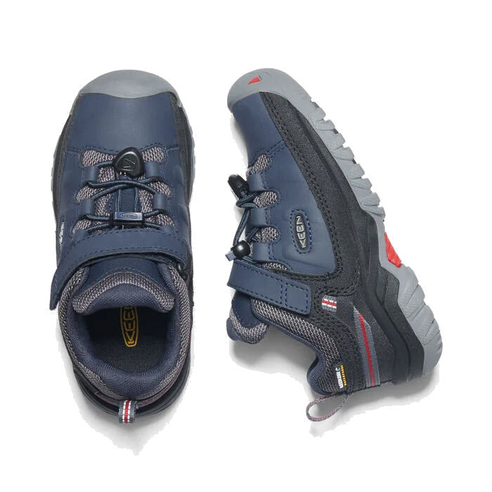 A pair of Keen Targhee Low Waterproof Blue - Kids hiking shoes with gray, non-marking rubber outsoles on a white background.