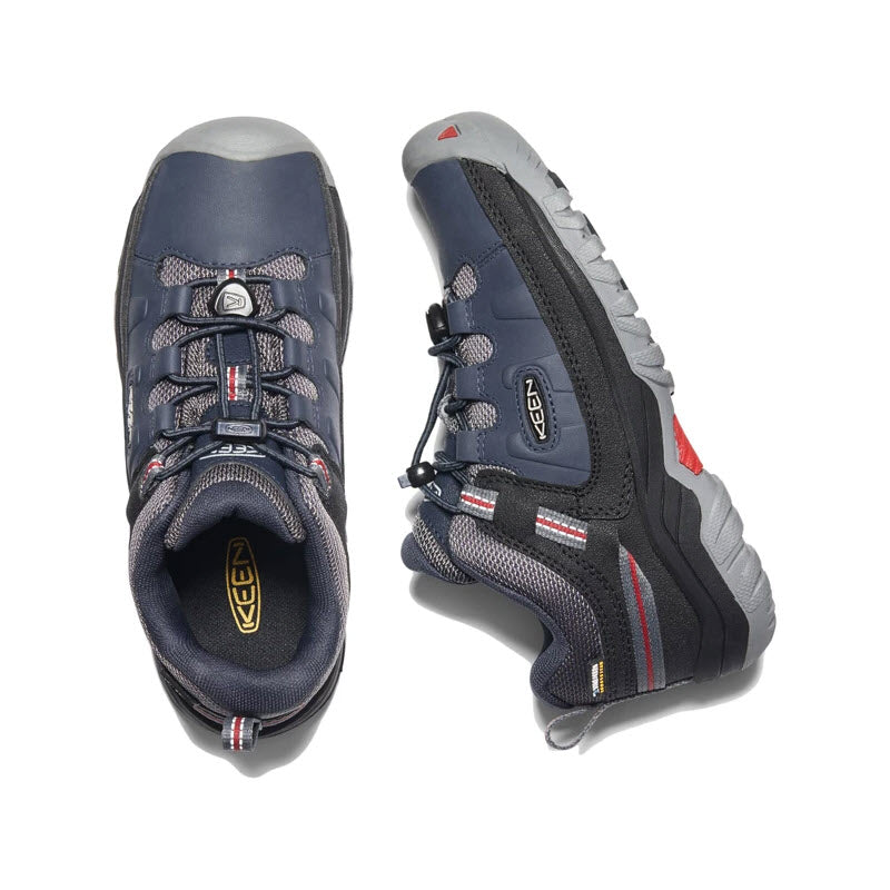 Pair of Keen Targhee Low WP Blue Kids hiking shoes, navy blue with gray soles and red accents, displayed from above with the left shoe facing forward and the right shoe facing backwards.