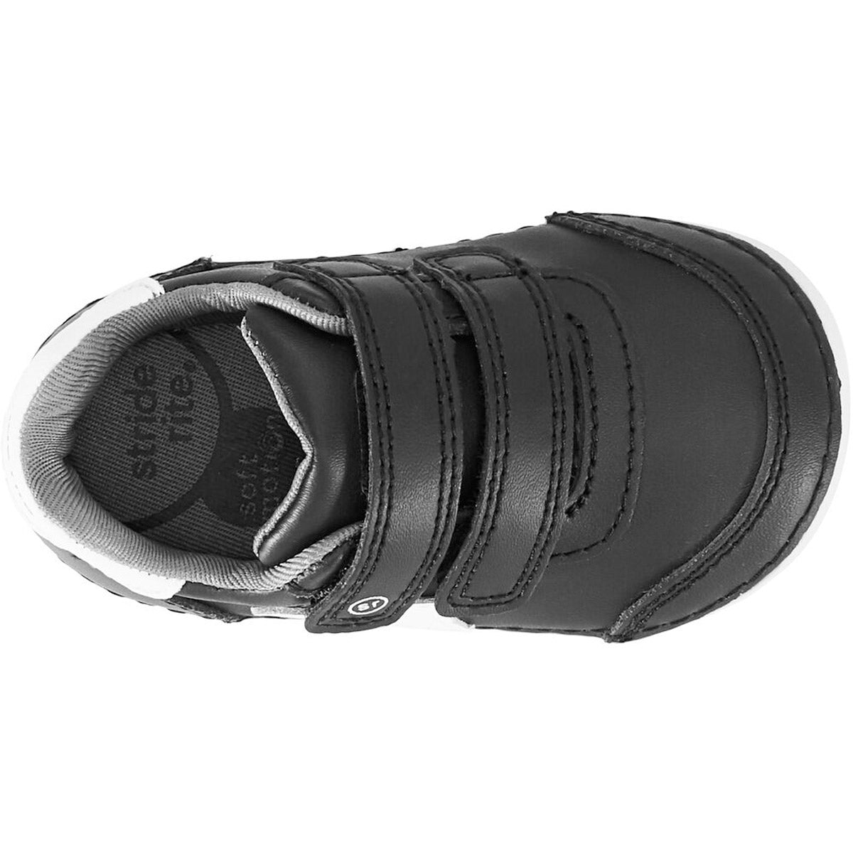 A single Stride Rite SM Kennedy Black kids shoe with double hook and loop closure viewed from above.