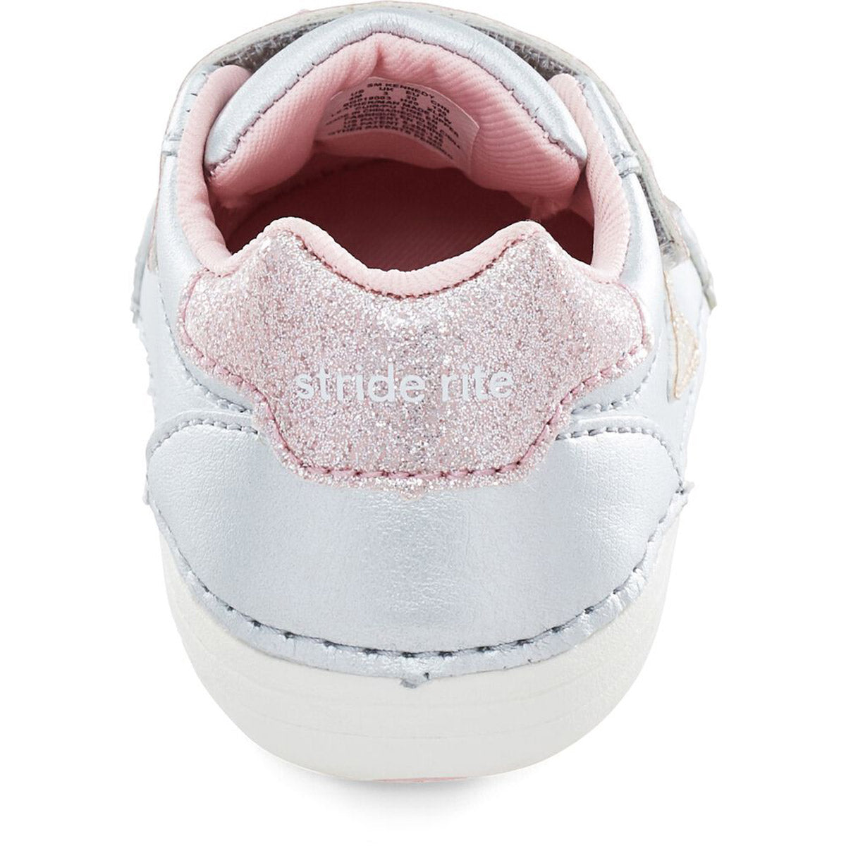 A close-up view of the back of a child&#39;s Stride Rite SM Kennedy Silver Multi - Kids athletic shoe with glitter detailing, featuring an adjustable double hook and loop closure.