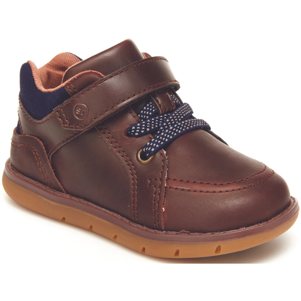 Child&#39;s brown leather Stride Rite Anders Brown Boots with blue accents and a dotted lace, featuring easy on-and-off design.