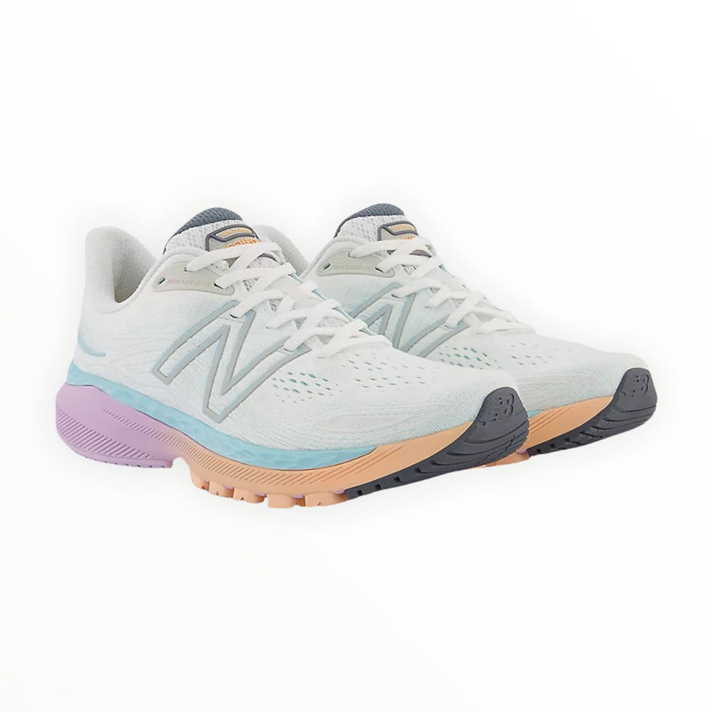 A pair of light blue New Balance 860V12 stability running shoes with white laces, featuring a lavender heel accent and tan soles, displayed against a white background.