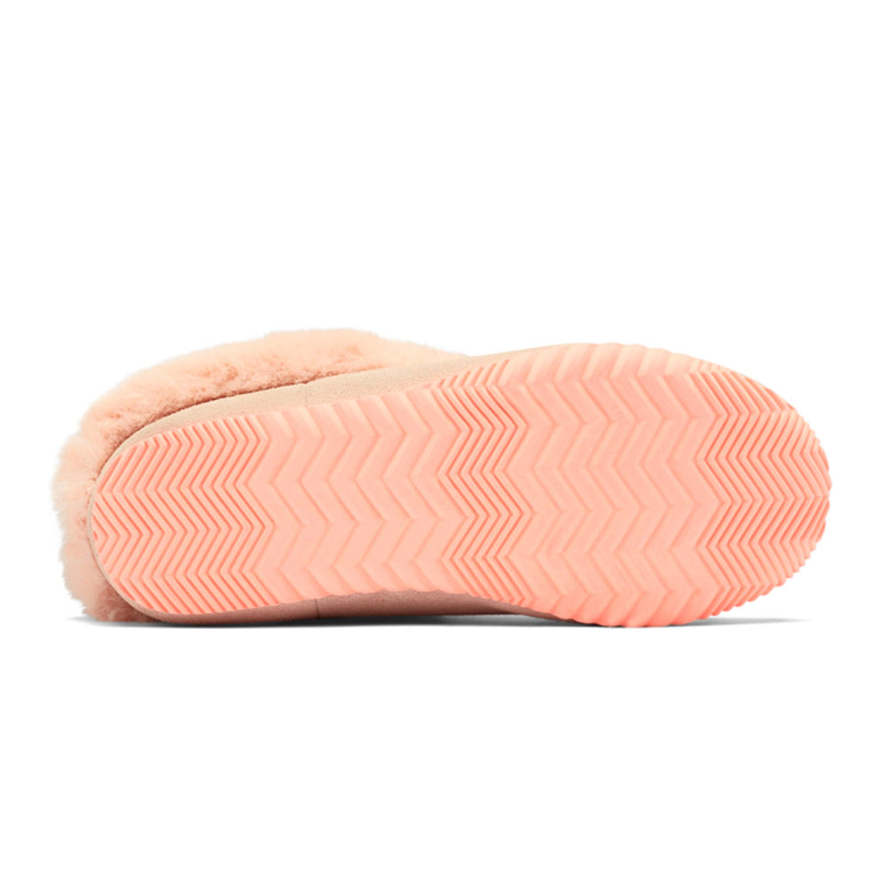 A single Sorel peach-colored slipper with a luxurious soft suede exterior and a plush faux fur interior, featuring a chevron-patterned sole.