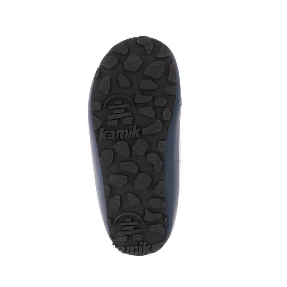 Sole of a Kamik Puffy Lavender slipper displaying its tread pattern and brand logo, highlighted by the faux fur lining peeking out.