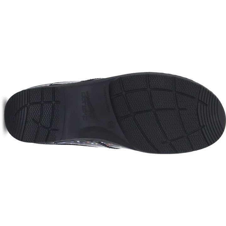 Black rubber sole of a Dansko LT Pro Confetti Patent women&#39;s clog with textured patterns for grip.