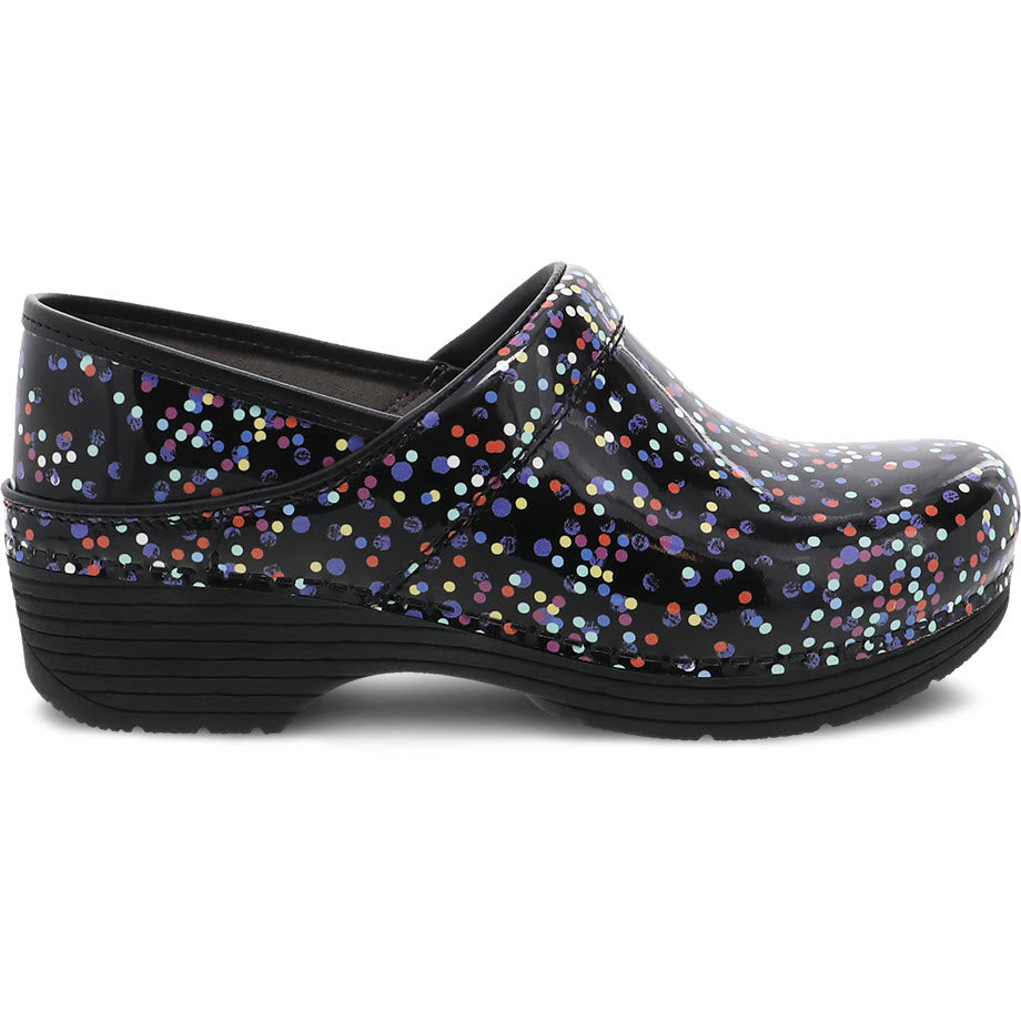 A black Dansko LT Pro Confetti Patent clog with colorful polka dots, a wedge heel, and a cushioned footbed.