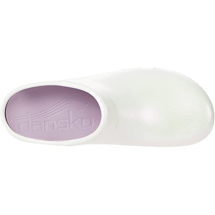 A single white Dansko Kane Pearl Iridescent clog with a visible brand imprint on the insole.