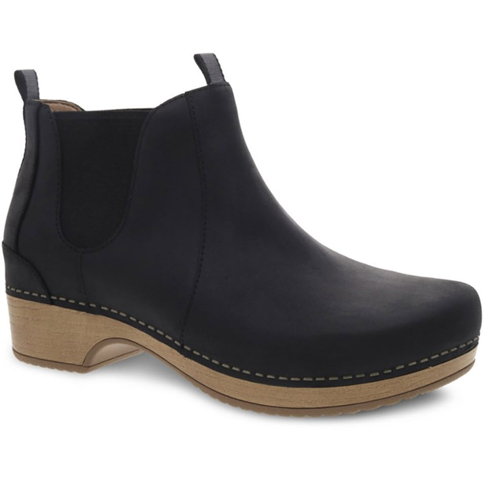 A black Dansko BECKA BLACK ankle boot with elastic side panels, nubuck uppers, and a low wooden heel featuring 3M™ Scotchgard™ protector.