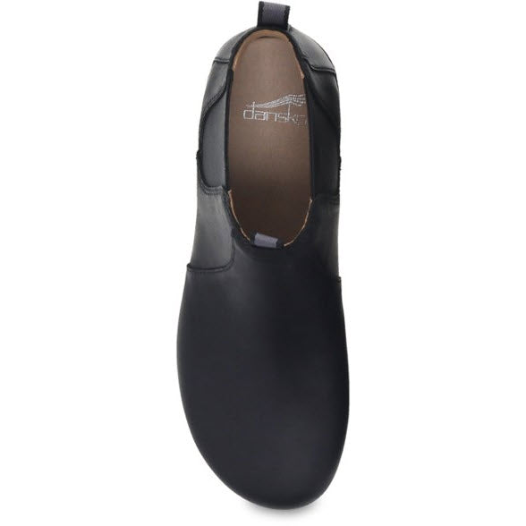 A single black slip-on shoe, featuring Dansko Becka Black - Women boots design with nubuck uppers, viewed from the top.