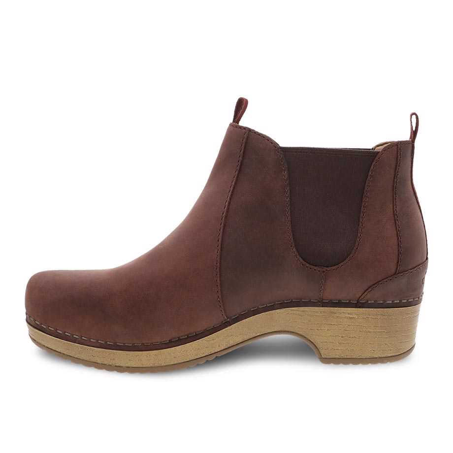 Brown leather low booties with elastic side panels, a wooden heel, and treated with 3M™ Scotchgard™ protector - Dansko Becka Mahogany Oiled Pull Up.