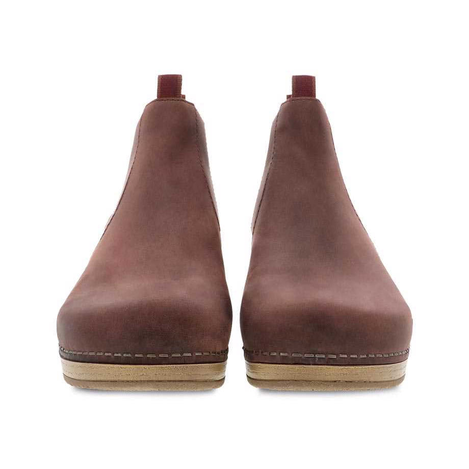 A pair of Dansko Becka Mahogany Oiled Pull Up low booties on a white background.