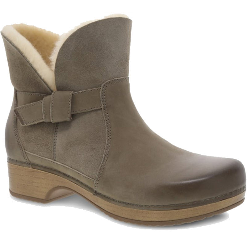 A Dansko Bessie Taupe Burnished Nubuck ankle boot with a shearling-lined interior and a decorative buckle.