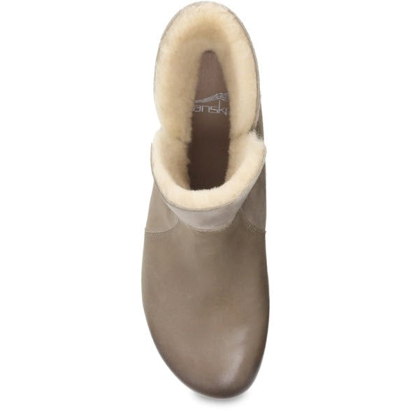 A top-down view of a single taupe Dansko Bessie Taupe Burnished Nubuck - Womens shearling-lined bootie.