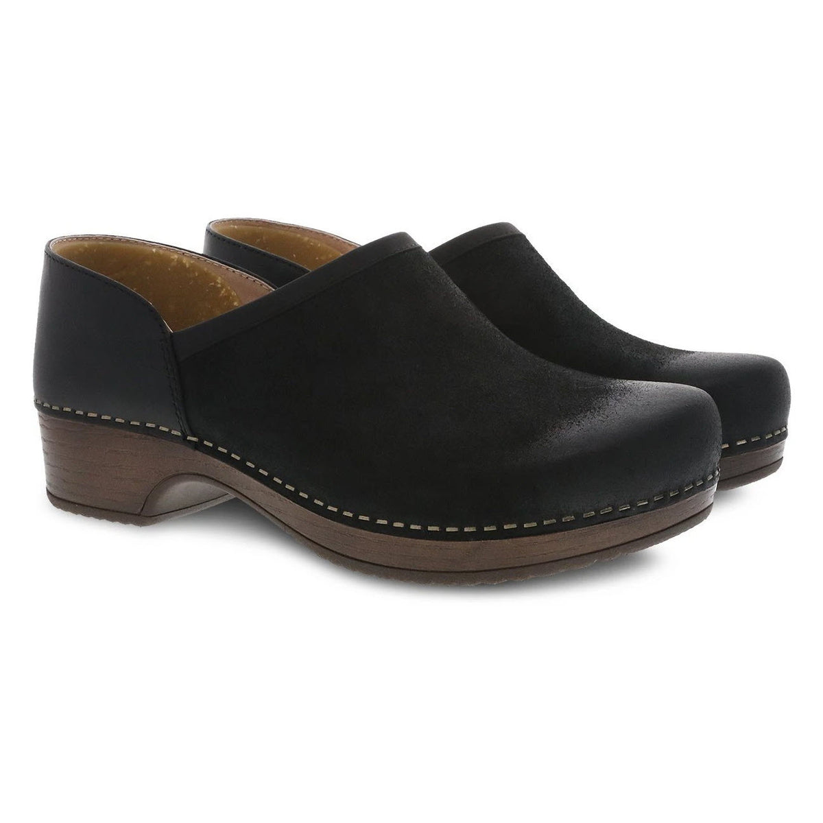 A pair of black Dansko Brenna Black Burnished Suede slip-on clog-style shoes on a white background.