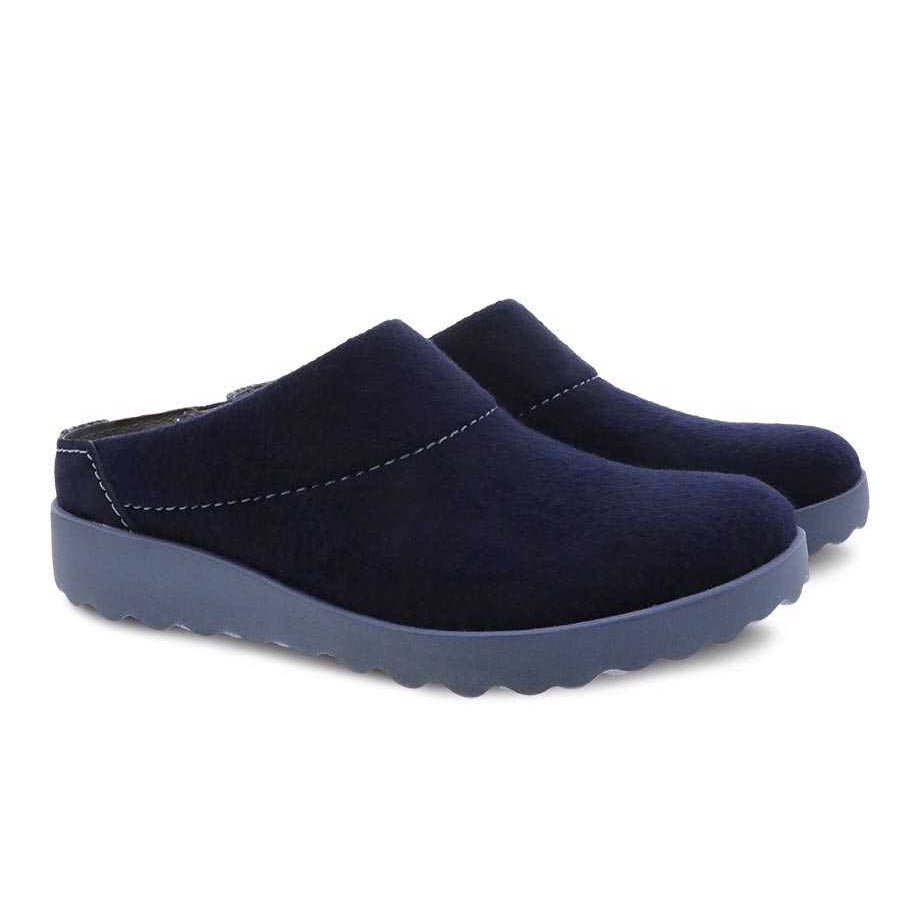 Pair of Dansko Lucie Navy Wool slip-on shoes with arch support isolated on a white background.