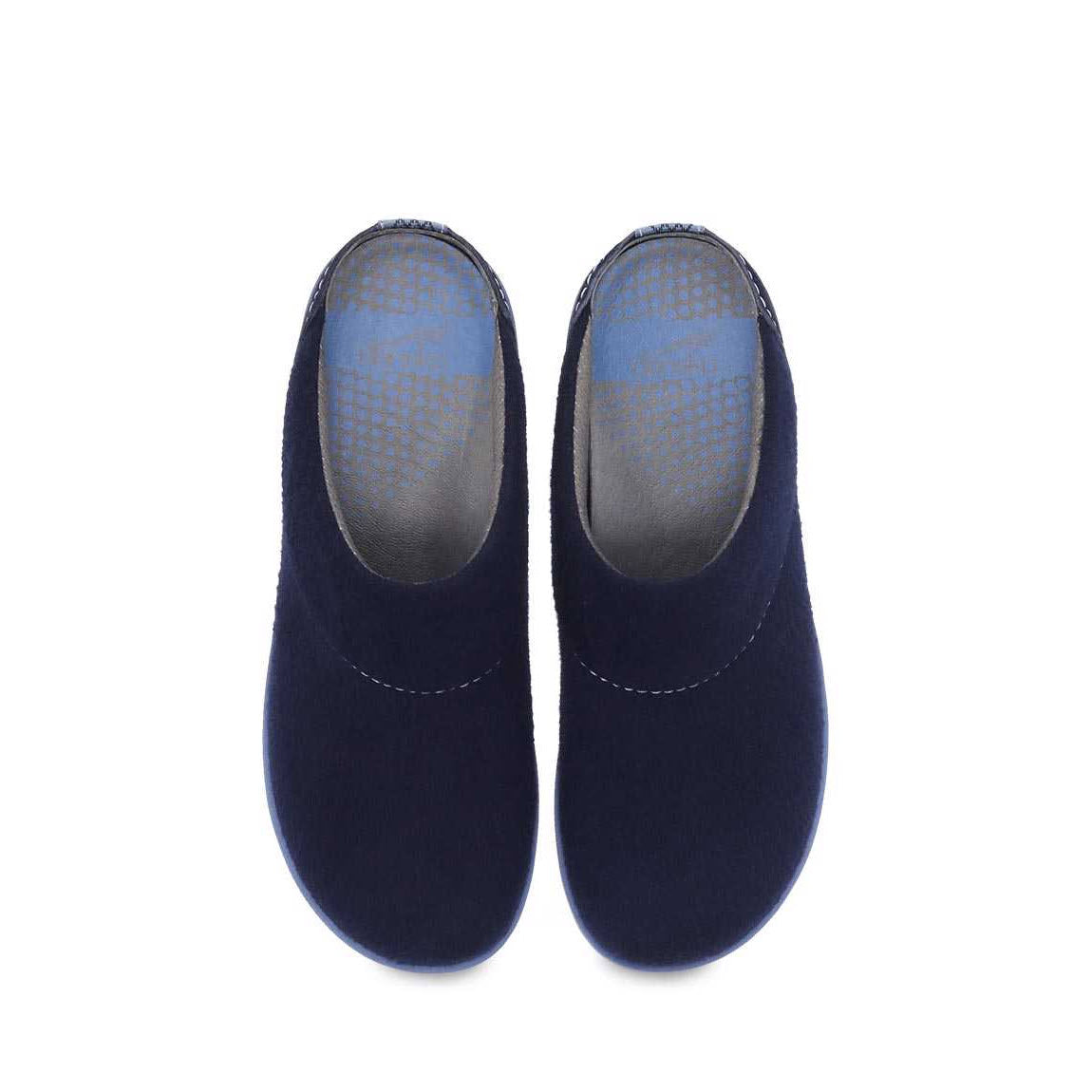A pair of navy blue Dansko Lucie wool slip-on shoes with wool blend uppers displayed on a white background.