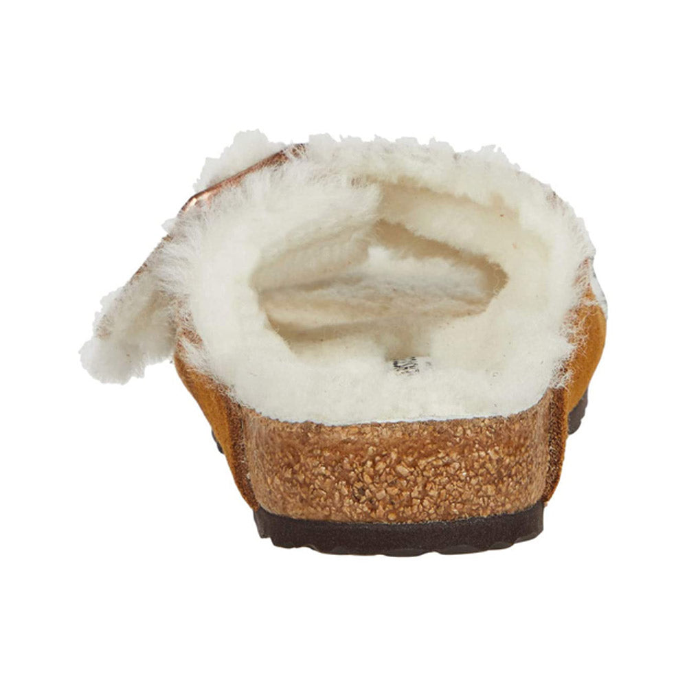 A sliced piece of bread with a bite taken from it, featuring a Birkenstock Arizona Shearling Mink - Womens texture, isolated on a white background.
