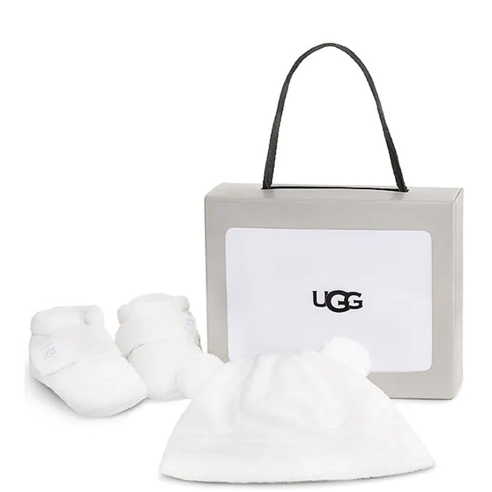 A set of snuggly soft Ugg Bixbee and Beanie Blanc de Blanc booties and a matching bear ear beanie presented in a Ugg branded gift box.