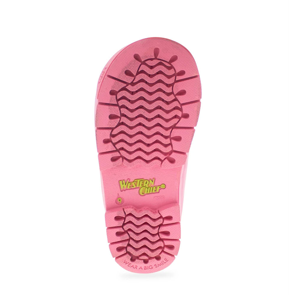 Sole of a pink Western Chief waterproof rain boot with chevron treads and Western Chief branding.