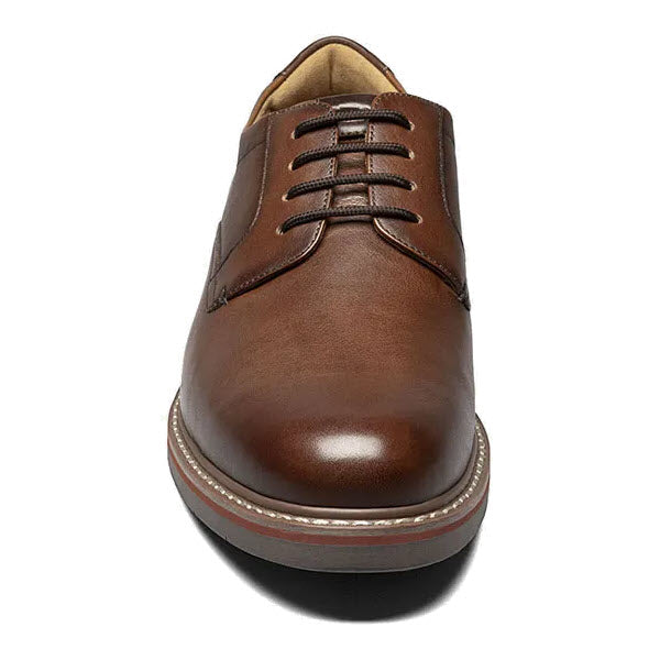 Brown Florsheim Norwalk Plain Toe Oxford Cognac dress shoe with a milled leather upper against a white background.