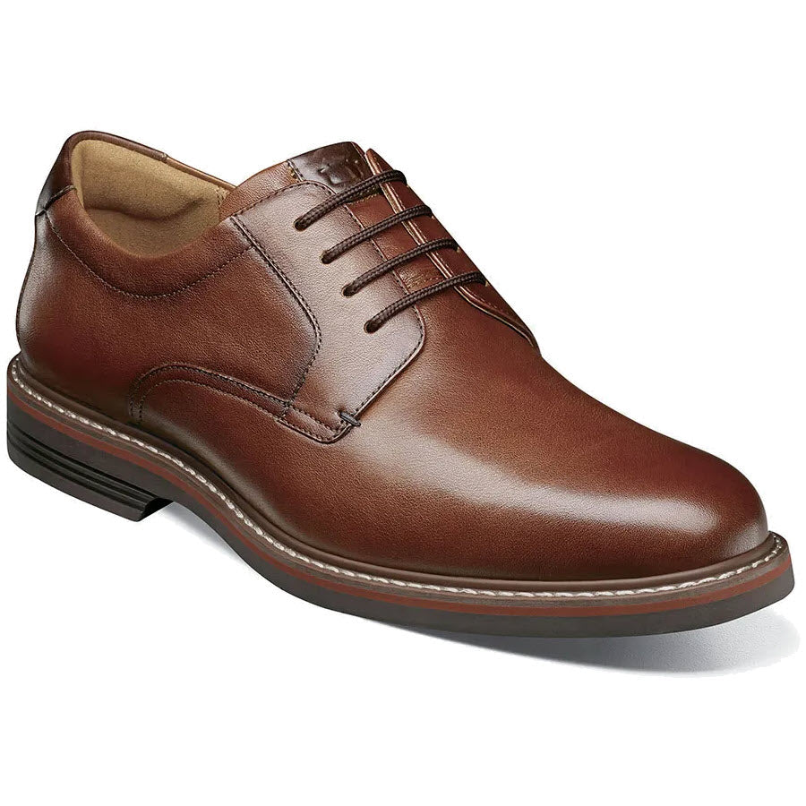A Florsheim Norwalk plain toe oxford cognac dress shoe with laces, featuring a milled leather upper, displayed on a white background.