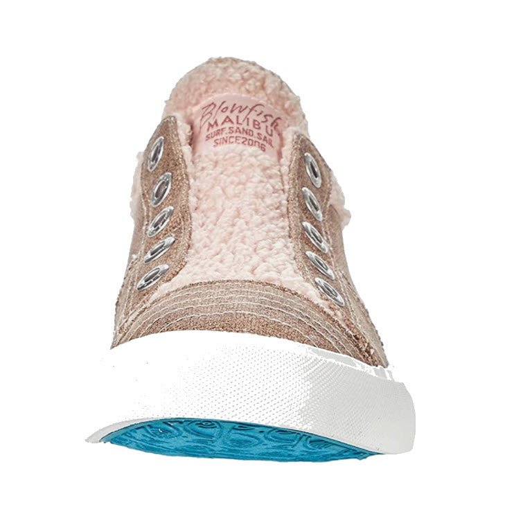 Beige canvas upper sneaker with white laces and a blue sole, viewed from the toe angle by Blowfish.