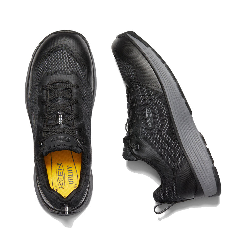 A pair of KEEN SPARTA II SOFT TOE ESD BLACK/GRAY - MENS sneakers, featuring a contrasting yellow insole and KEEN.ReGEN midsole, viewed from above.