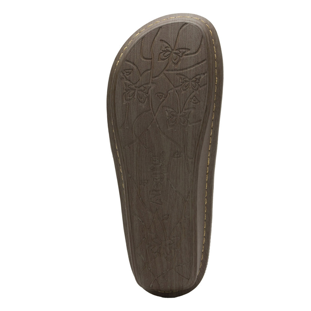 A single Alegria Brenna Peaceful Easy brown women&#39;s shoe sole with patterned tread and stitched edges.