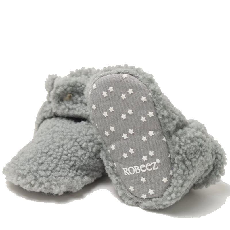 A pair of gray baby booties with star patterns and the brand &quot;Robeez&quot; on the sole.