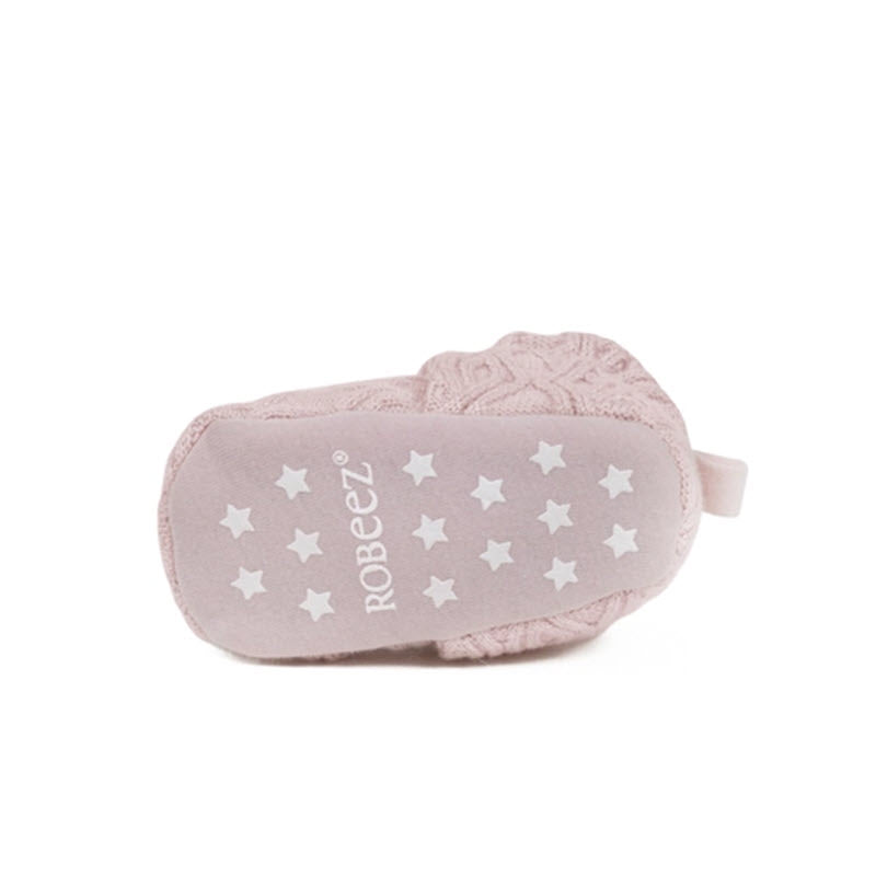 A light pink Robeez Snap Booties with white star patterns and the brand &quot;Robeez&quot; displayed on it, isolated on a white background.