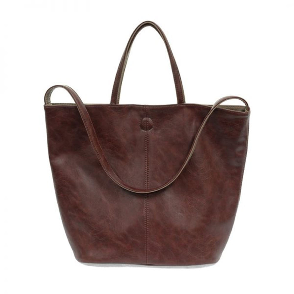 JOY SUSAN RENEE REVERSIBLE TOTE BAG OXBLOOD/FAWN made of vegan leather, isolated on a white background.