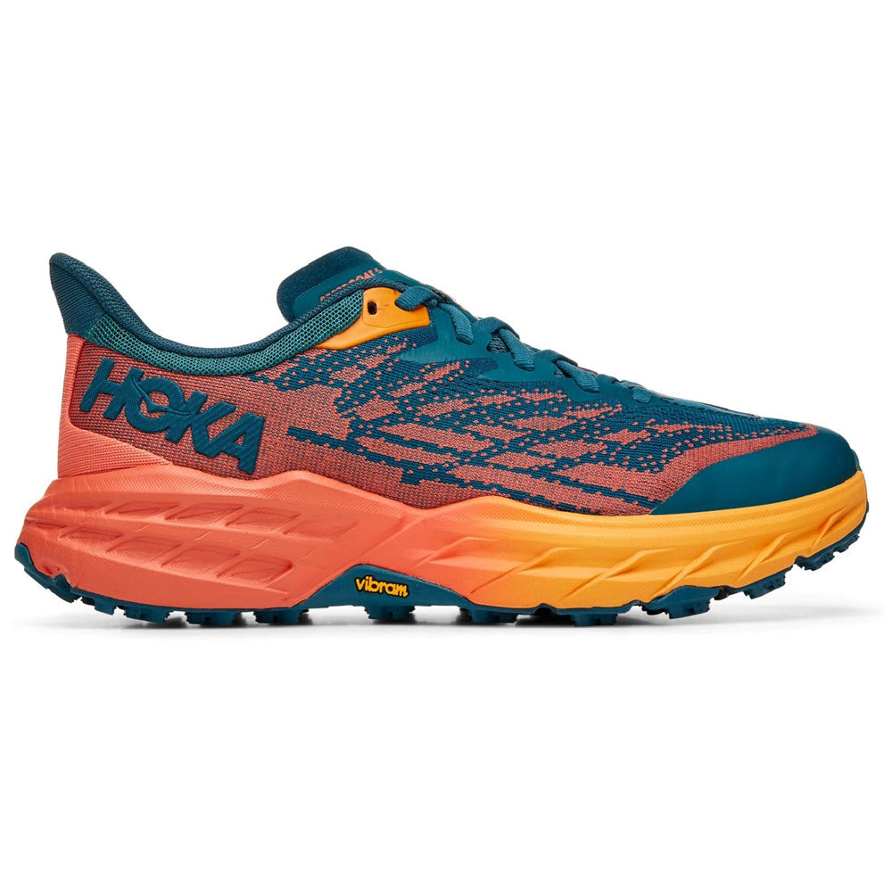 A single Hoka trail running shoe featuring a blue and orange color scheme with a prominent "hoka" logo and a Vibram® Megagrip outsole, designed for the Speedgoat 5 series