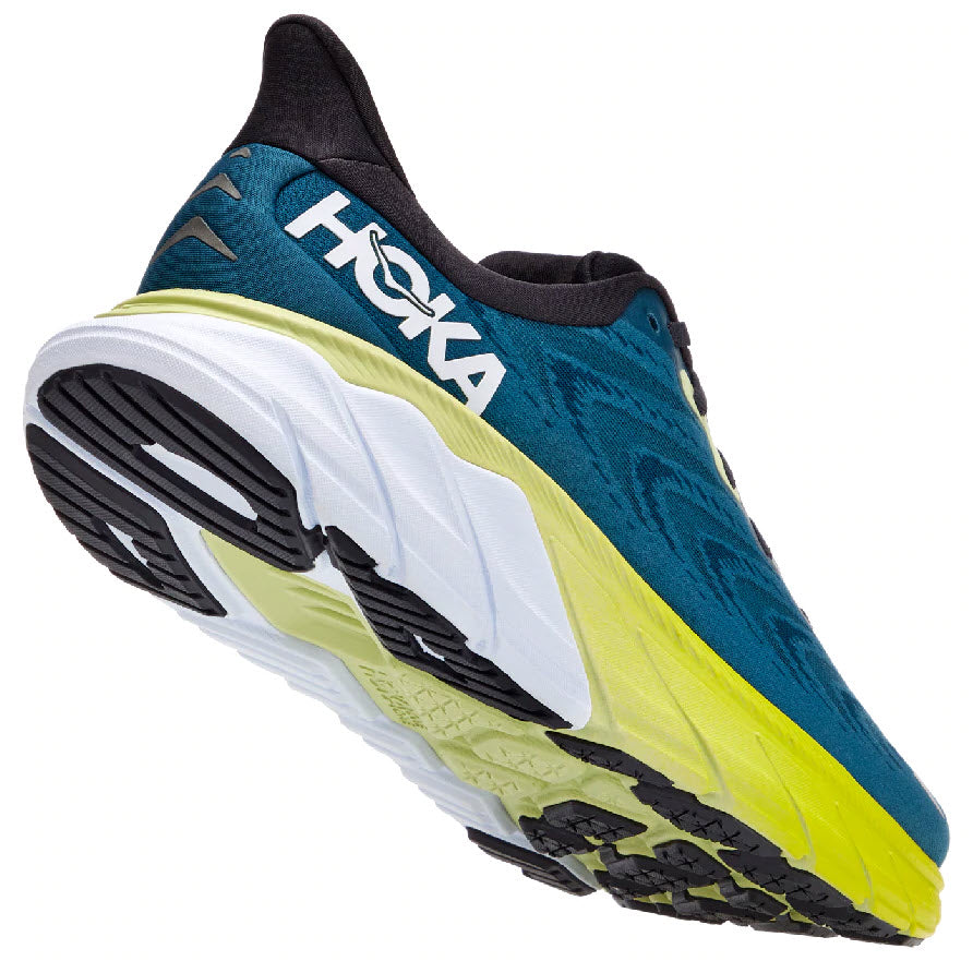 A lateral view of a blue and yellow HOKA ONE ONE Arahi stability shoe with maximal cushioning.
