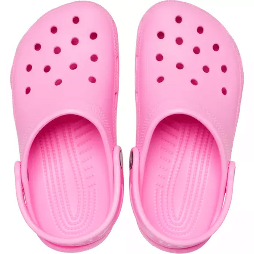 A pair of Grade School Girls&#39; Crocs Classic Taffy Pink clogs viewed from above, made from Croslite material.