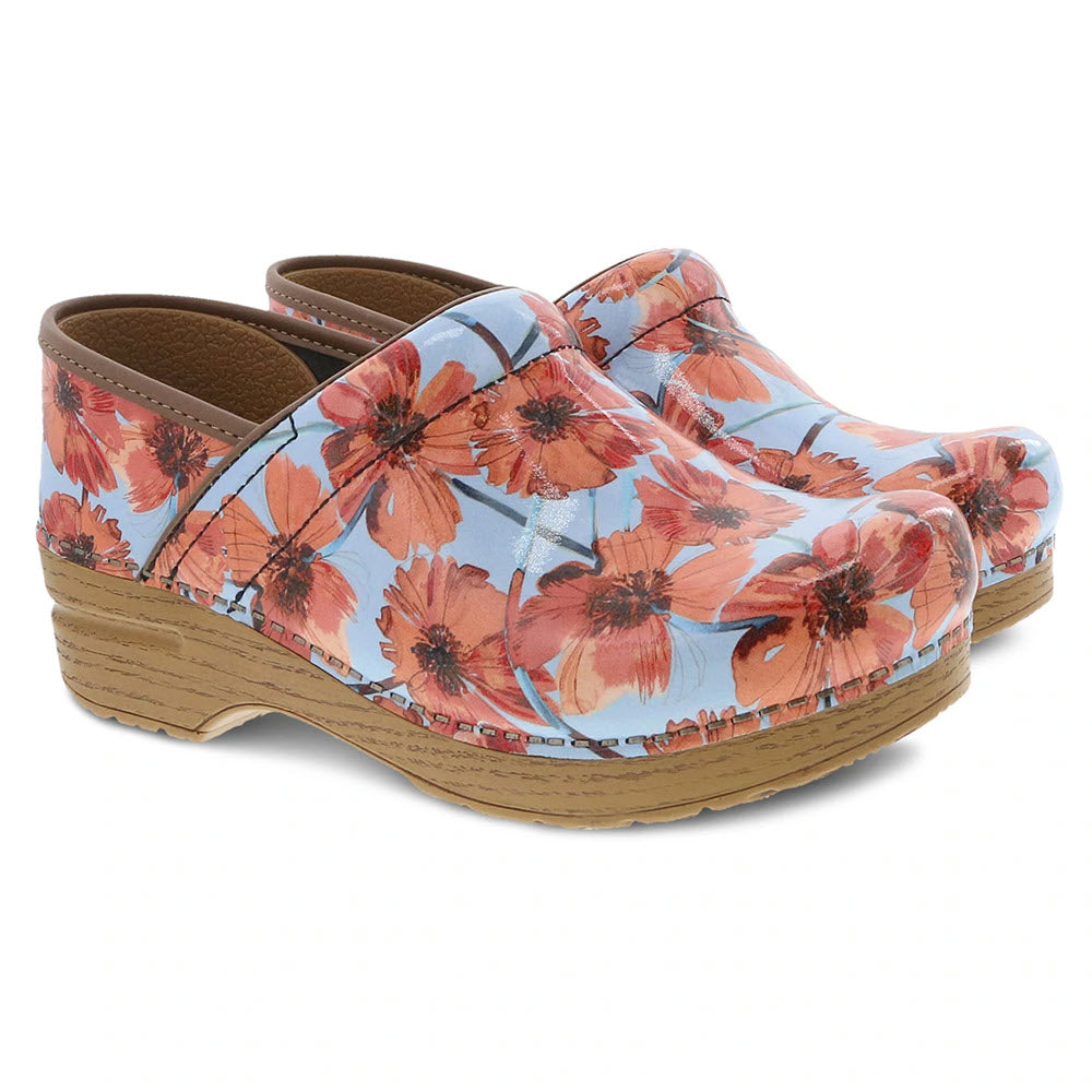 Dansko Professional Poppies Patent Clog with floral patterned upper and wooden soles, designed for all-day comfort and support on a white background.