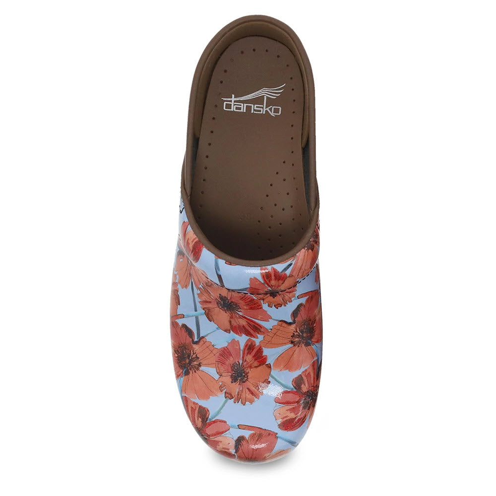 A floral-patterned Dansko Professional Poppies Patent Clog viewed from above, providing all-day comfort and support.