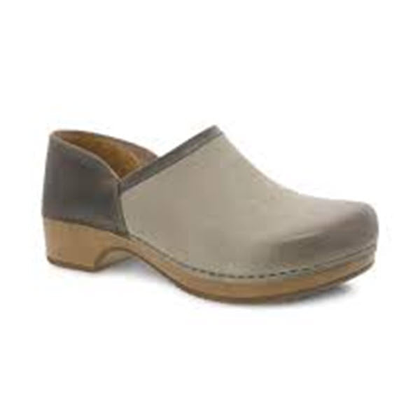 A two-tone Dansko Brenna Taupe Burnished clog with a beige upper, dark gray toe cap, and wooden sole, featuring a memory foam footbed, isolated on a white background.