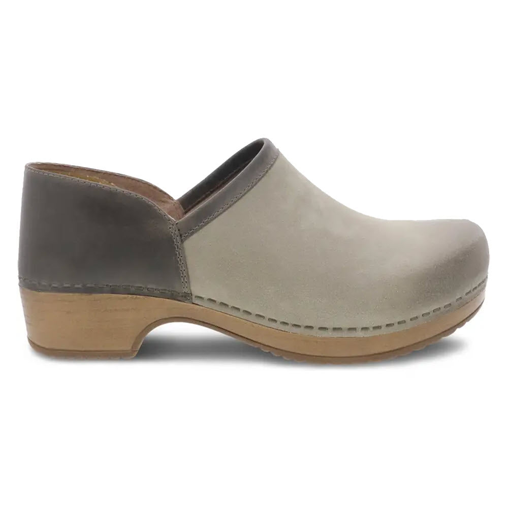 A two-tone Dansko Brenna Taupe Burnished clog featuring a beige front and dark brown back with a wooden sole, slight heel, and memory foam footbed.