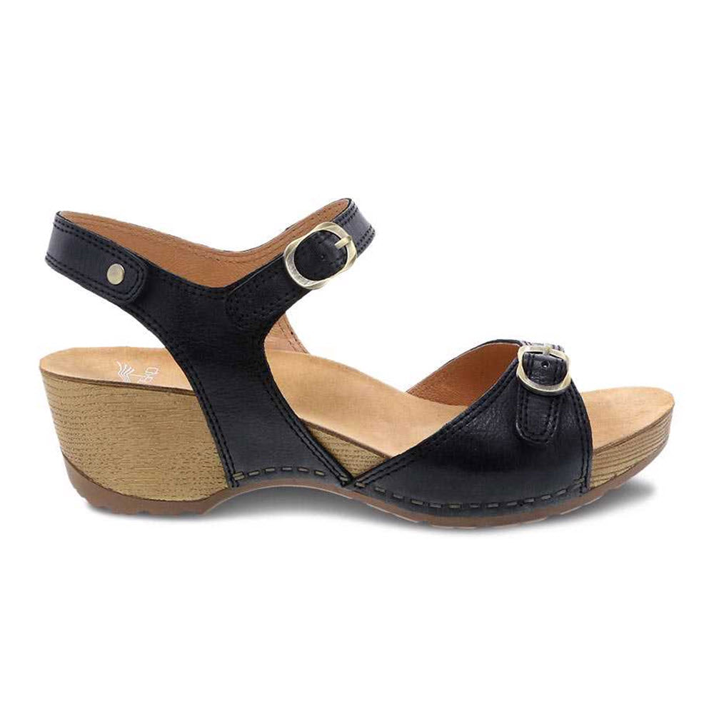 Dansko Tricia Black Milled Burnished Women&#39;s Sandal with ankle strap and leather linings on a white background.