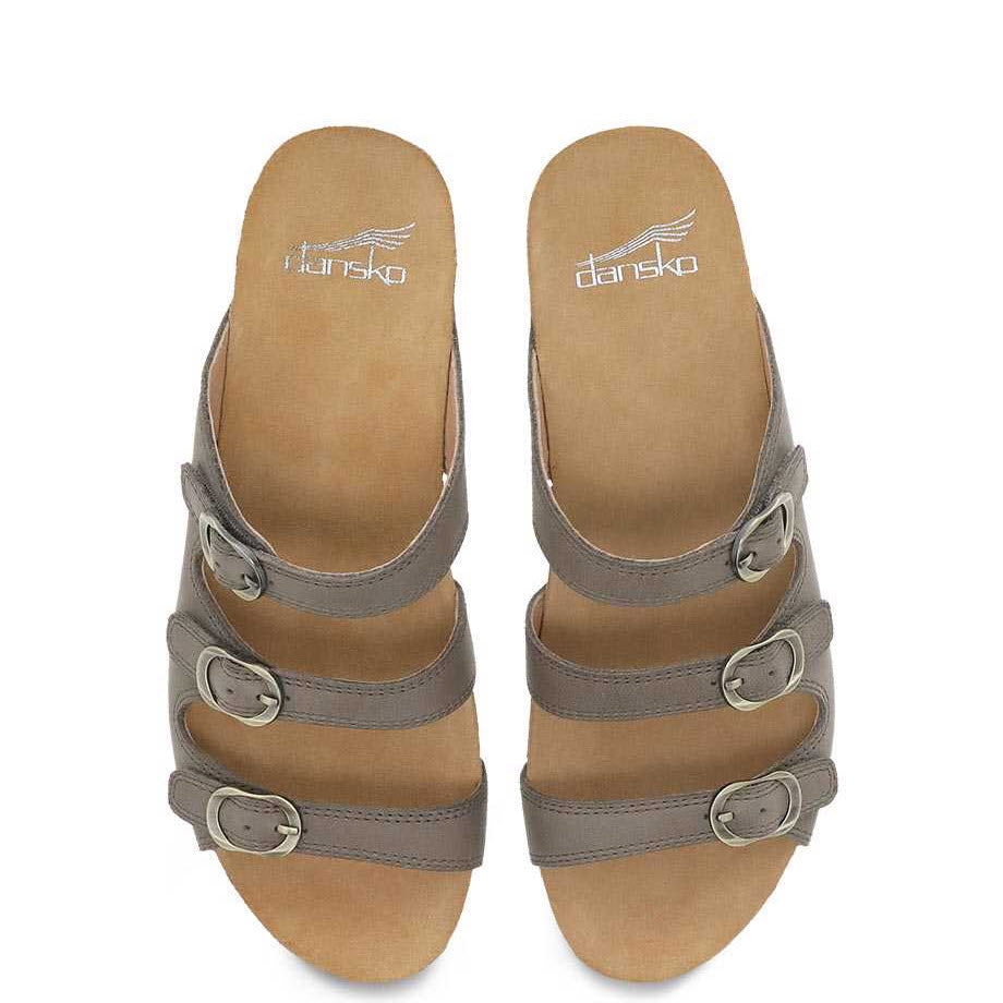 A pair of beige Dansko Tarin Taupe Burnished Nubuck strappy sandals with adjustable forefoot straps and buckles on a white background.