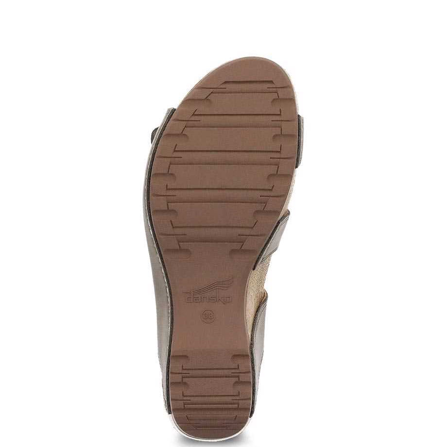 Sole of a Dansko Tarin Taupe Burnished Nubuck sandal with textured tread and a visible Dansko brand name.