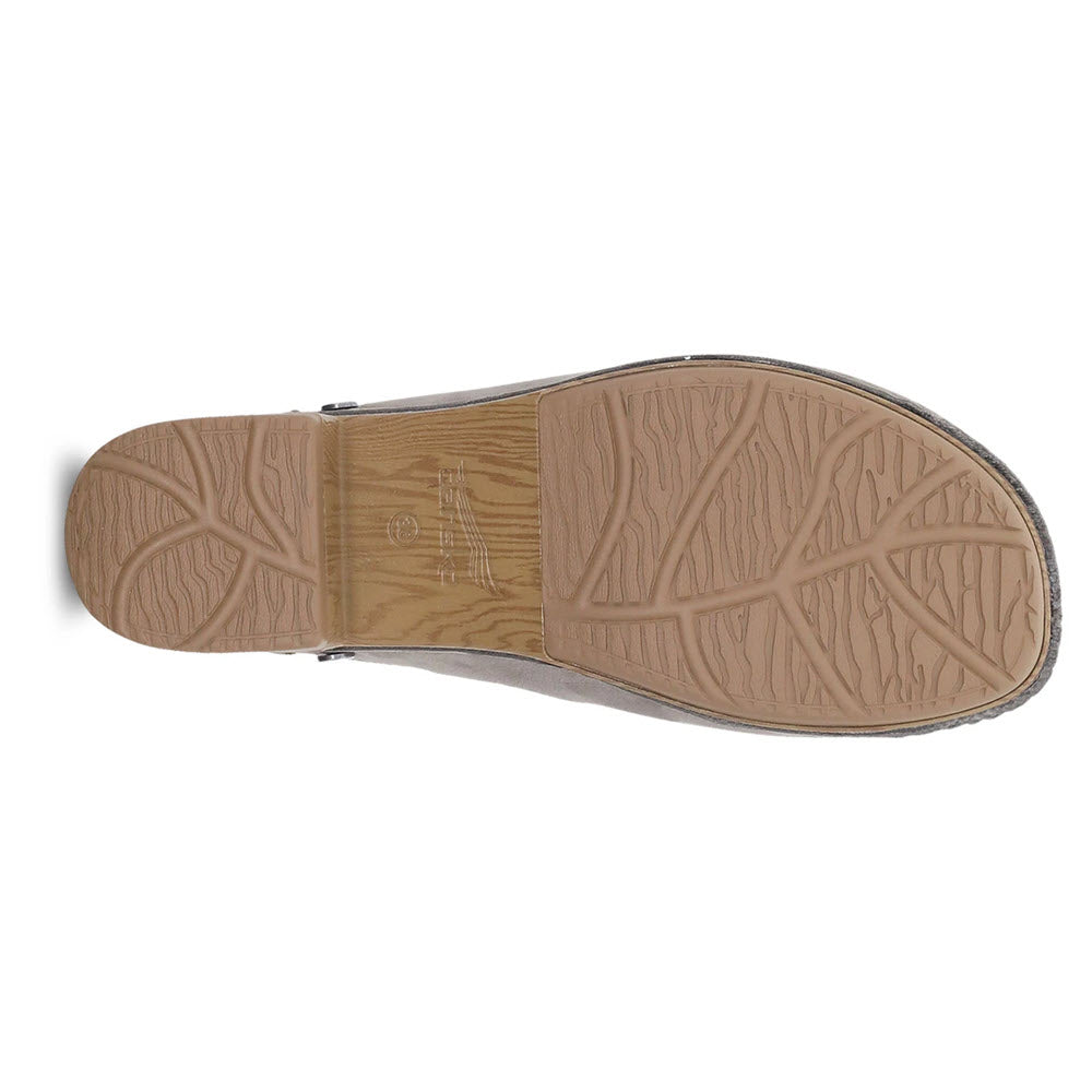 Sole of a Dansko Giulia Milled Nubuck Taupe shoe with tread pattern displayed on a white background.