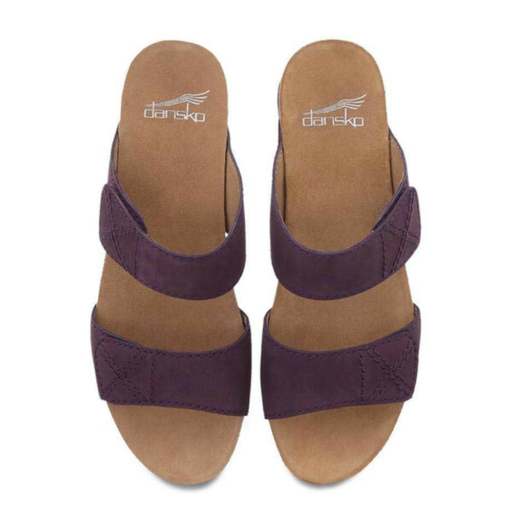 A pair of DANSKO MADDY PURPLE NUBUCK wedge sandals with a leather upper and an open-back double strap slide design.