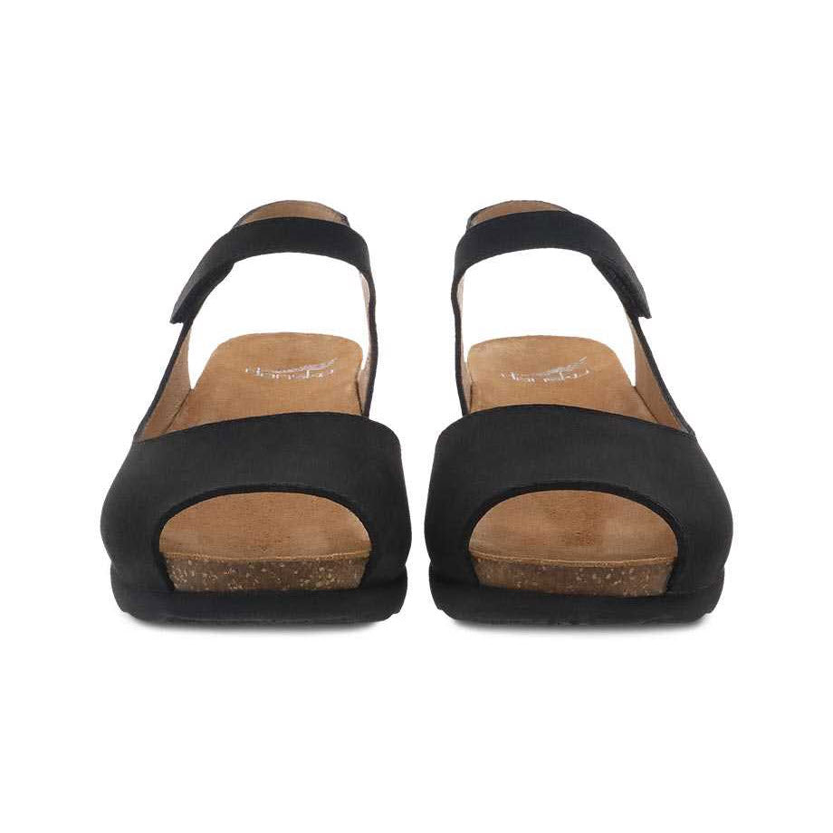 A pair of black suede Dansko Marcy Wedge platform sandals viewed from the front.
Product Name: DANSKO MARCY BLACK MILLED NUBUCK - WOMENS
Brand Name: Dansko