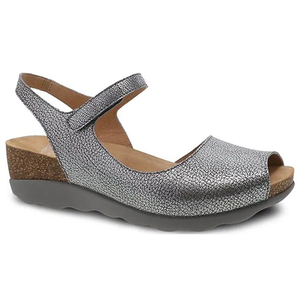 Dansko Marcy Pewter Metallic women&#39;s wedge sandal with an adjustable ankle strap.