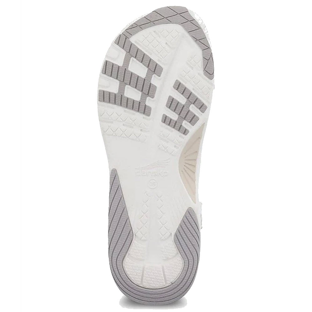 Bottom view of a Dansko Racquel sandal sole displaying its tread pattern and brand logo, featuring Dansko&#39;s Natural Arch Technology.
