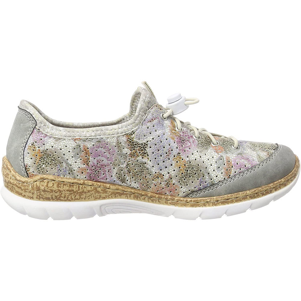 Women&#39;s Rieker multi-colored slip-on shoe with cork detailing and a white sole.