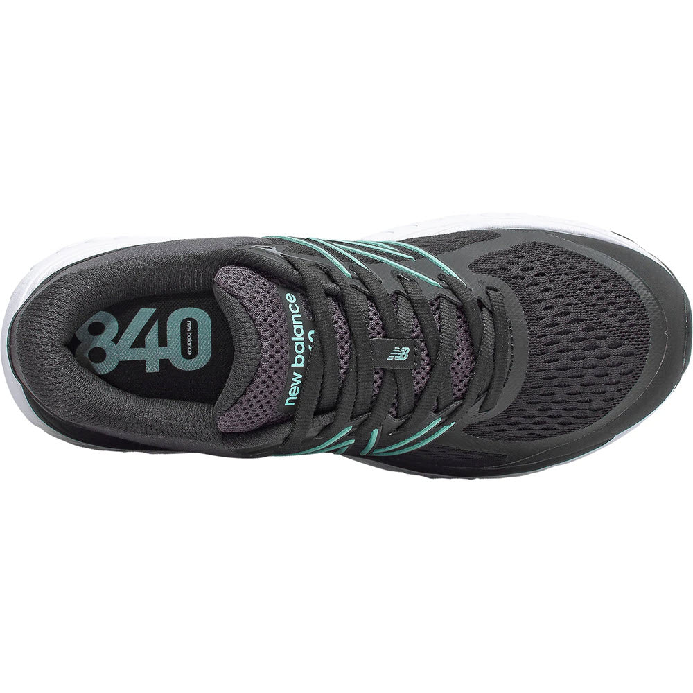 Top view of a black New Balance 840v5 women&#39;s running shoe with teal accents and foam cushioning.